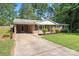 Ranch-style brick home with a carport, well-maintained lawn, and simple landscaping, offering comfortable living at 4322 Greenhaven Ln, Gastonia, NC 28056