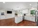 Updated eat-in kitchen featuring stainless steel appliances, an island with counter seating, and a view to the yard at 4322 Greenhaven Ln, Gastonia, NC 28056