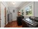 A modern laundry room with a large window features a washer and dryer set and wood flooring at 4322 Greenhaven Ln, Gastonia, NC 28056