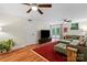 A naturally lit living room features hardwood floors, a ceiling fan, and access to the backyard at 4322 Greenhaven Ln, Gastonia, NC 28056