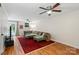 Spacious living room features hardwood floors, a ceiling fan, and access to the backyard at 4322 Greenhaven Ln, Gastonia, NC 28056