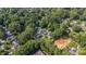 Expansive aerial view of the property surrounded by lush greenery in a peaceful neighborhood at 4349 Castleton Rd, Charlotte, NC 28211