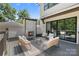 Outdoor deck featuring a cozy fireplace, comfortable seating, and sliding glass doors to the interior at 4349 Castleton Rd, Charlotte, NC 28211