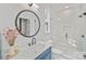 Bathroom with walk-in shower, undermount sink with oil rubbed bronze faucet, and unique round mirror at 4349 Castleton Rd, Charlotte, NC 28211