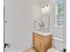 A bathroom vanity with a mirror, sink, and toilet at 4349 Castleton Rd, Charlotte, NC 28211