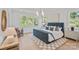 Bright bedroom featuring a blue bed frame, hardwood floors, and natural light from multiple windows at 4349 Castleton Rd, Charlotte, NC 28211