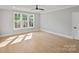 Bright bedroom features hardwood floors, neutral walls, a ceiling fan and large windows at 4349 Castleton Rd, Charlotte, NC 28211