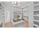 Large walk-in closet featuring custom shelves, and storage solutions with modern light fixture at 4349 Castleton Rd, Charlotte, NC 28211