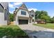 Beautiful two-story modern farmhouse with stylish brick accents, well-manicured lawn, and paved driveway at 4349 Castleton Rd, Charlotte, NC 28211