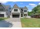 Charming two-story modern farmhouse with stylish brick accents, well-manicured lawn, and paved driveway at 4349 Castleton Rd, Charlotte, NC 28211