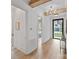 A foyer with wood flooring, a decorative light fixture, and a view of the outside at 4349 Castleton Rd, Charlotte, NC 28211