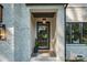 Close-up of the home's front door with black trim, decorative light fixture and 'welcome' mat at 4349 Castleton Rd, Charlotte, NC 28211
