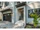 Stylish front entrance with brickwork, black trim windows, and a modern glass front door at 4349 Castleton Rd, Charlotte, NC 28211
