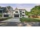 Striking two-story home with modern design, neat lawn, dark garage door, and paved driveway at 4349 Castleton Rd, Charlotte, NC 28211
