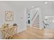 Entryway showcases hardwood floors, a staircase, and modern decor at 4349 Castleton Rd, Charlotte, NC 28211