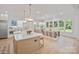 Bright, open kitchen with large island, light wood cabinetry, and adjacent dining area at 4349 Castleton Rd, Charlotte, NC 28211
