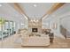 Bright living room featuring hardwood floors, fireplace, exposed beams, and access to outdoor patio at 4349 Castleton Rd, Charlotte, NC 28211