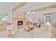 Cozy living room with a fireplace, hardwood floors, natural wood beam accents, and elegant furnishings at 4349 Castleton Rd, Charlotte, NC 28211
