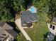 Aerial view of a home with a pool, driveway, and well-manicured lawn at 5051 Carillon Way, Charlotte, NC 28270