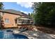 A brick house and screened-in porch overlook a brick paver pool deck at 5051 Carillon Way, Charlotte, NC 28270