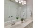 Bathroom featuring a double vanity with white countertops and cabinetry, a large mirror, and modern fixtures at 5051 Carillon Way, Charlotte, NC 28270