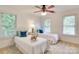 Bright and airy bedroom with twin beds, soft carpeting, and a ceiling fan at 5051 Carillon Way, Charlotte, NC 28270