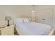 Cozy bedroom featuring neutral carpet, a bed with decorative pillows, and a bedside table with a lamp at 5051 Carillon Way, Charlotte, NC 28270