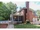 Exterior view of a brick house with a screened porch and pool area at 5051 Carillon Way, Charlotte, NC 28270