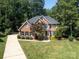 A brick home with a well-kept lawn and symmetrical landscaping exudes curb appeal at 5051 Carillon Way, Charlotte, NC 28270