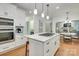This stylish kitchen features a large island with a gas cooktop and stainless steel appliances at 5051 Carillon Way, Charlotte, NC 28270