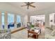 Comfortable living room with a fireplace, ceiling fan, and screened-in porch access at 5051 Carillon Way, Charlotte, NC 28270