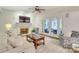 This cozy living room features a fireplace, ceiling fan, and access to a screened-in porch at 5051 Carillon Way, Charlotte, NC 28270