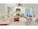 Spacious living room with fireplace, ceiling fan, and access to the screened-in porch at 5051 Carillon Way, Charlotte, NC 28270