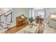 Inviting living room featuring wood floors and a piano at 5051 Carillon Way, Charlotte, NC 28270