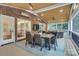 Beautiful covered patio featuring exposed brick, a dining table and outdoor seating at 5051 Carillon Way, Charlotte, NC 28270