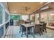 Entertain on this lovely screened-in porch with an outdoor dining table and a built-in grill at 5051 Carillon Way, Charlotte, NC 28270