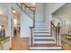 Elegant staircase with white spindles and wood treads at 5051 Carillon Way, Charlotte, NC 28270