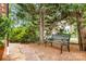 Landscaped backyard with mature trees and a black metal bench for relaxing and enjoying the peaceful setting at 5205 Tedorill Ln, Charlotte, NC 28226