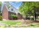 Home's lush backyard with mature trees, complemented by a rock garden and stone path at 5205 Tedorill Ln, Charlotte, NC 28226