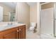 Bright bathroom with shower, toilet, cabinet sink, and neutral tile floors at 5205 Tedorill Ln, Charlotte, NC 28226