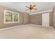 Spacious bedroom features large window for natural light and a ceiling fan at 5205 Tedorill Ln, Charlotte, NC 28226