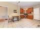 Bright dining area features built-in wood cabinetry, a table and chairs, and tile flooring at 5205 Tedorill Ln, Charlotte, NC 28226