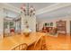 Open dining area featuring hardwood floors, an elegant chandelier, and seamless flow to the living spaces at 5205 Tedorill Ln, Charlotte, NC 28226