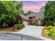 Charming brick home featuring a well-manicured lawn and a spacious driveway leading to an attached garage at 5205 Tedorill Ln, Charlotte, NC 28226