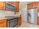 A stainless steel microwave, oven, and refrigerator shine against the light wood cabinetry at 5205 Tedorill Ln, Charlotte, NC 28226
