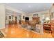 Spacious living room featuring hardwood floors, a cozy fireplace, and an open layout connecting to the dining area at 5205 Tedorill Ln, Charlotte, NC 28226