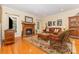 Inviting living room featuring a brick fireplace, hardwood floors, and comfortable seating with natural light at 5205 Tedorill Ln, Charlotte, NC 28226