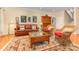 Cozy living room showcasing a leather sofa, a vintage display cabinet, and an inviting ambiance for relaxation at 5205 Tedorill Ln, Charlotte, NC 28226