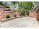 Private patio space featuring brick walls, stone pavers, statue, decorative plants, and access to the yard at 5205 Tedorill Ln, Charlotte, NC 28226