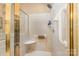 Accessible shower with grab bar, built-in seat, and tiled walls for safety at 5205 Tedorill Ln, Charlotte, NC 28226